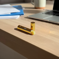 Everyday | The office setting with the laptop suggests the lip balm is part of a daily routine.